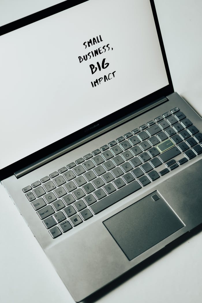 A laptop screen with the text 'Small Business, Big Impact,' symbolizing modern entrepreneurship.